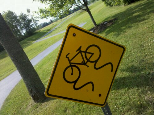watch out for skidding bicycles, sign along a bike path